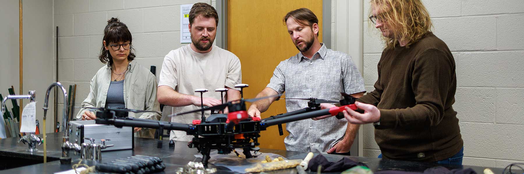 Doug Edmonds and four students work together on the construction of a drone outfitted with a camera.